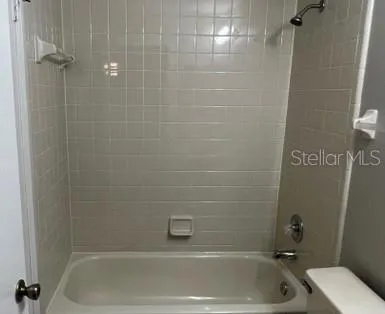 a bathroom with a tub and a shower