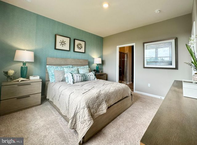 a bedroom with a bed and a lamp