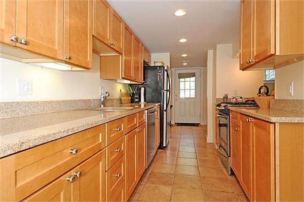 136-138 Middlesex Road, Unit B Chestnut Hill, MA 02467 - Photo 3 of 13 a kitchen with stainless steel appliances granite countertop a refrigerator and a sink