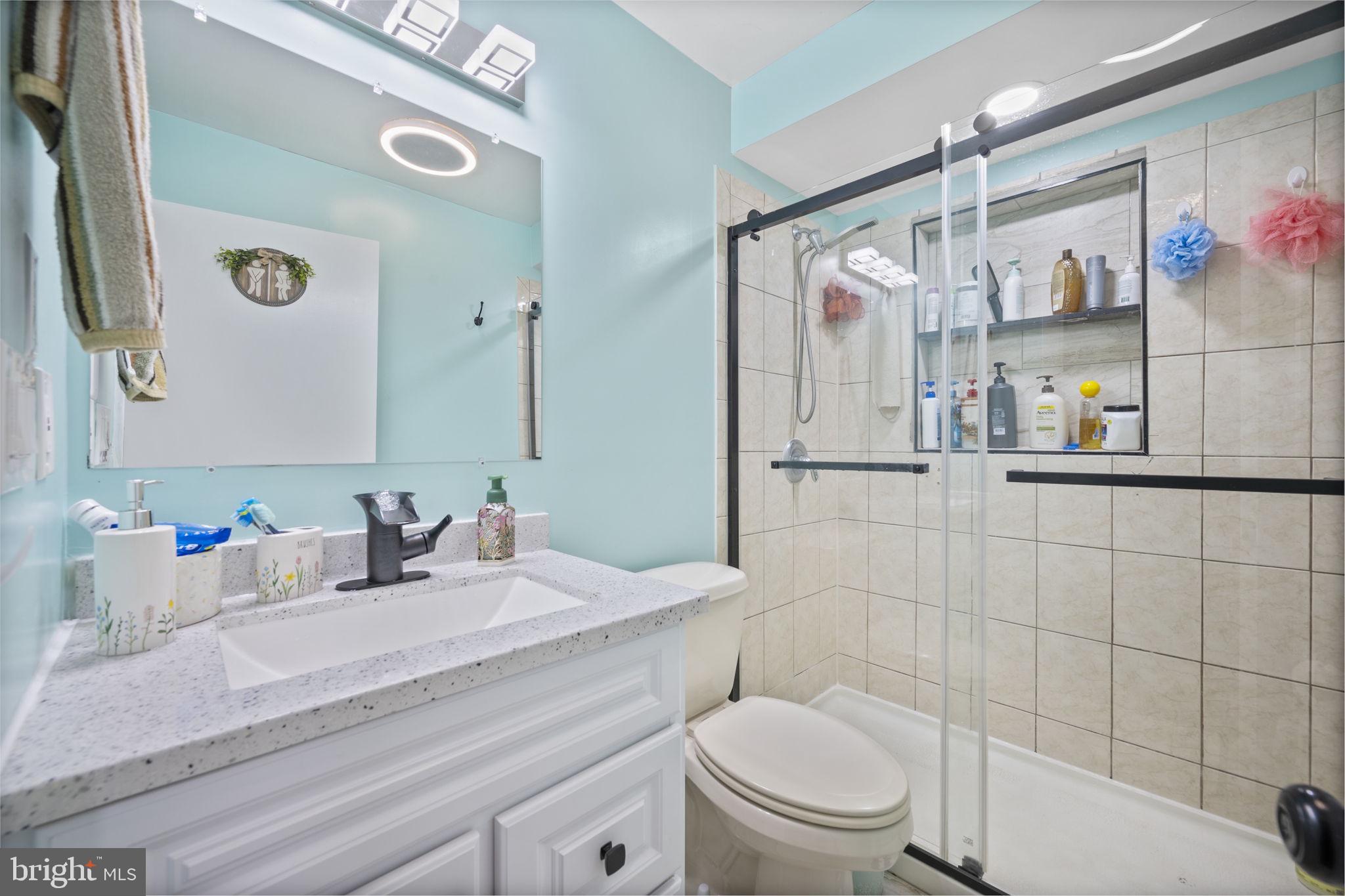 7715 Old Battle Grove Road Dundalk, MD 21222 - Photo 12 of 61 a bathroom with a sink a toilet and shower