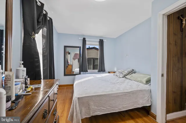a view of a hallway with wooden floor and stairs