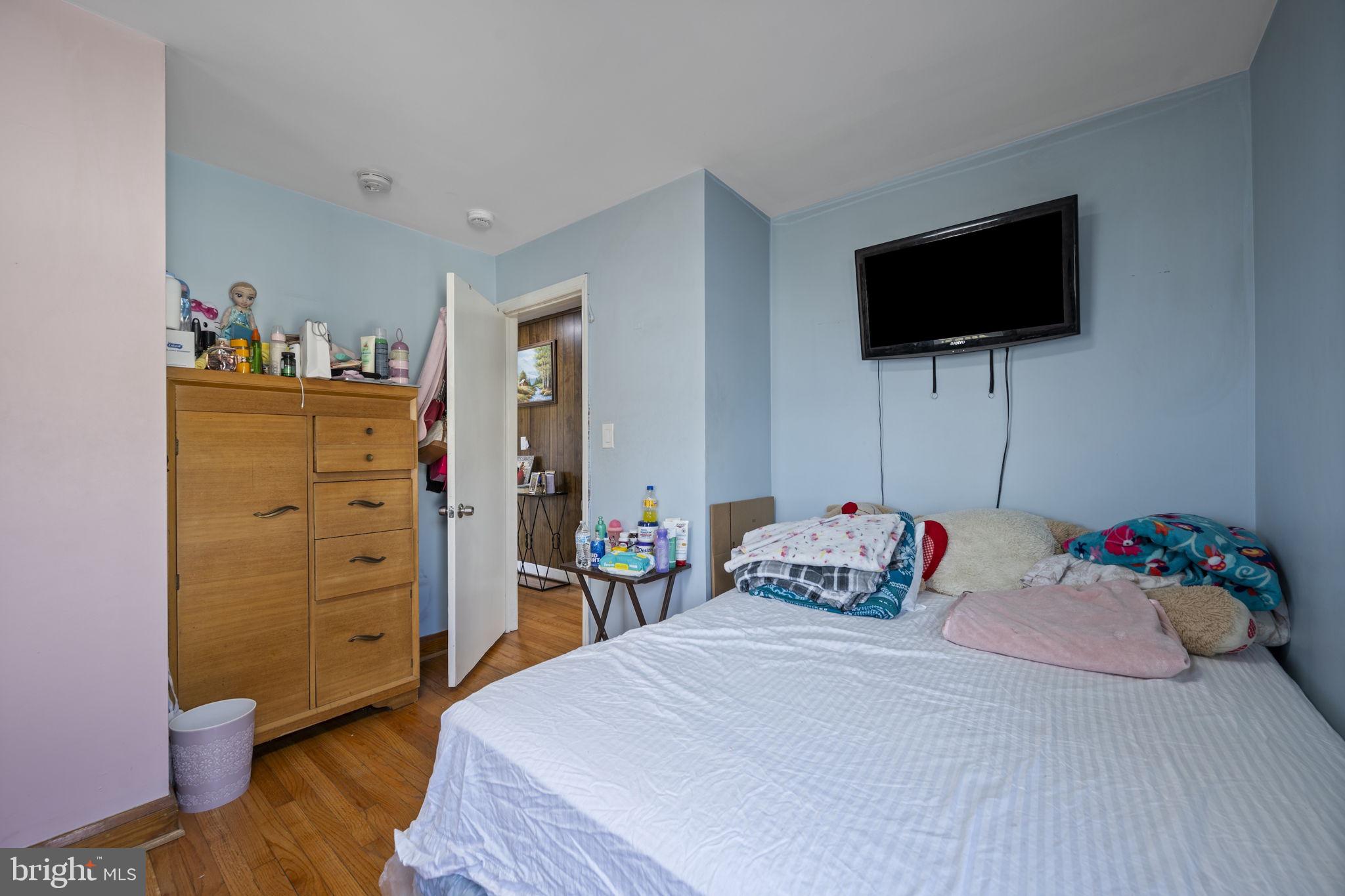 7715 Old Battle Grove Road Dundalk, MD 21222 - Photo 17 of 61 a bedroom with a bed and a flat screen tv