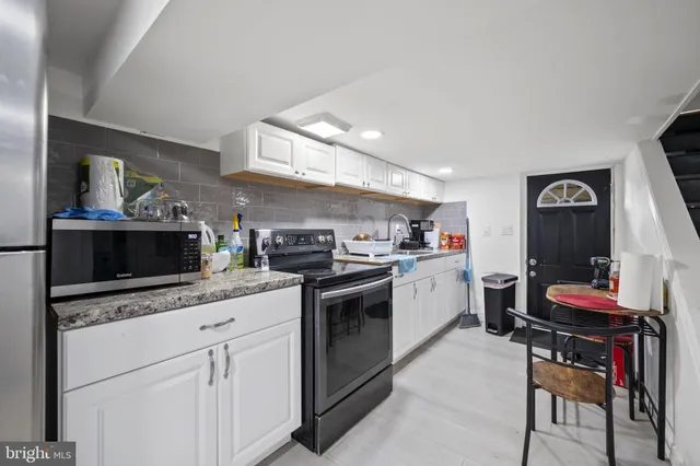 a view of a room with wooden floor and window
