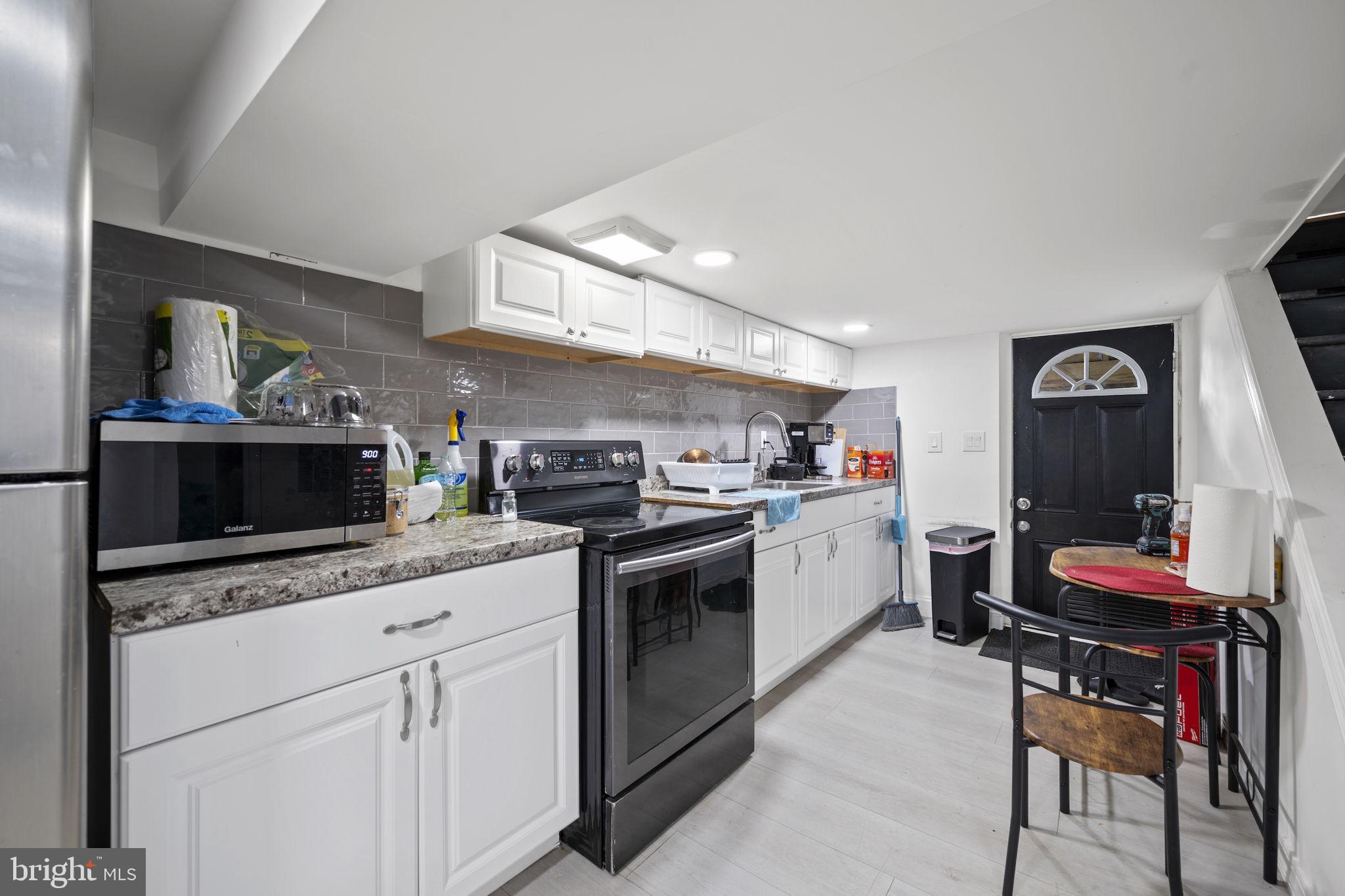 7715 Old Battle Grove Road Dundalk, MD 21222 - Photo 25 of 61 a kitchen with a sink cabinets and appliances
