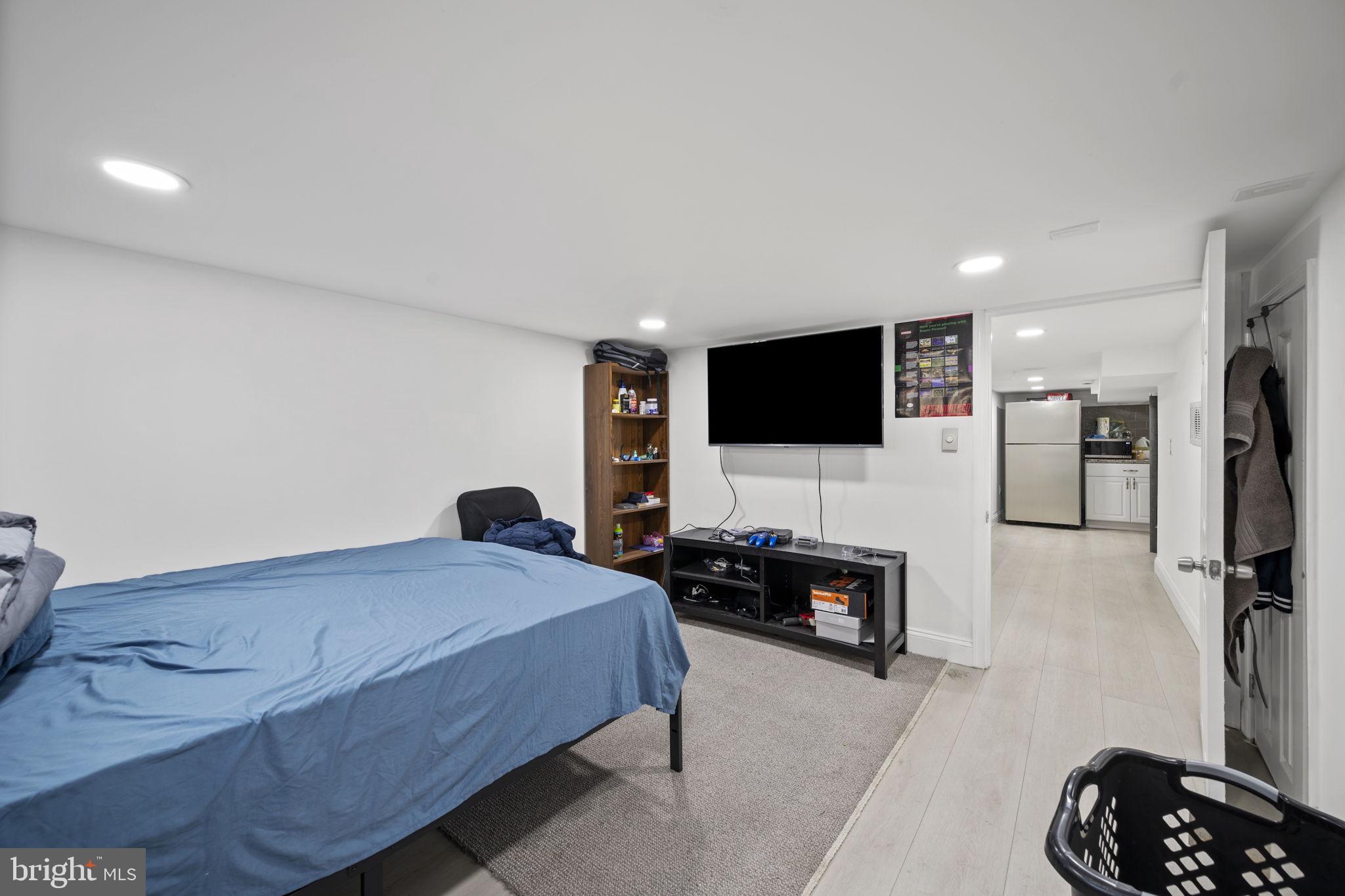 7715 Old Battle Grove Road Dundalk, MD 21222 - Photo 32 of 61 a bedroom with a bed and a flat screen television