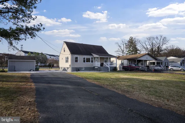 a view of a house with a yard and sitting area