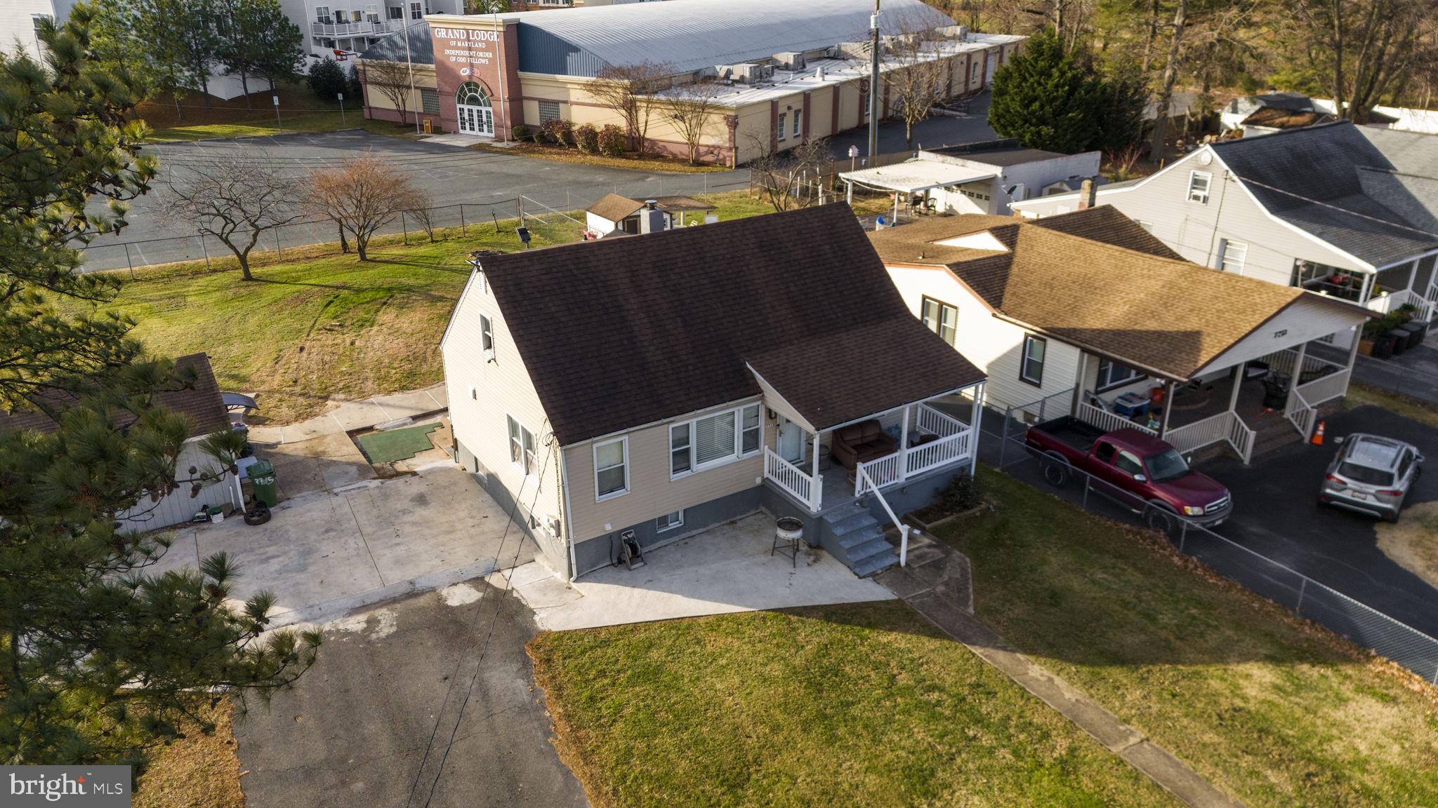 7715 Old Battle Grove Road Dundalk, MD 21222 - Photo 46 of 61 an aerial view of a house with pool lawn chairs and a yard