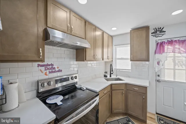 a kitchen with a sink stove and cabinets