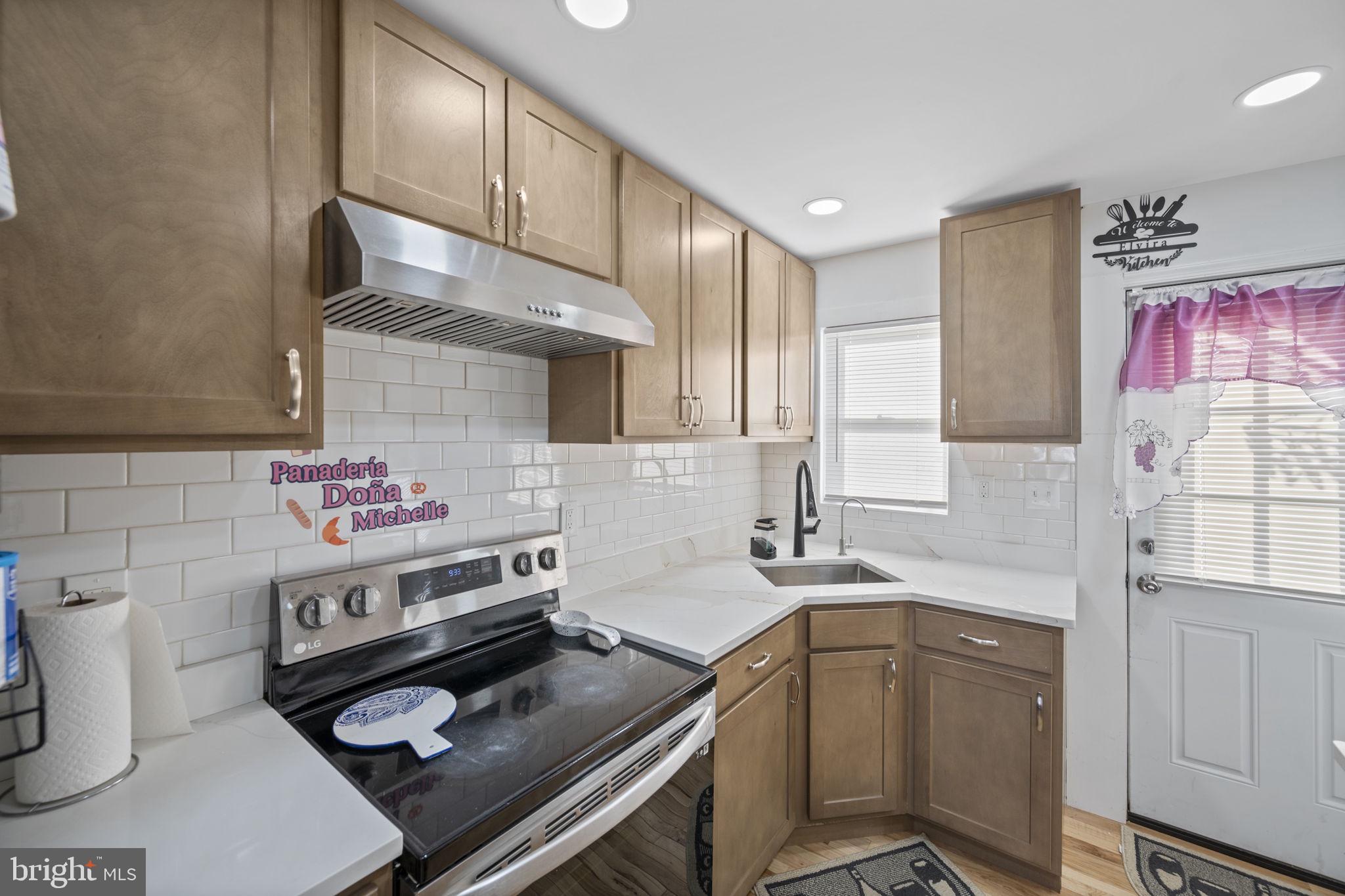 7715 Old Battle Grove Road Dundalk, MD 21222 - Photo 6 of 61 a kitchen with a sink stove and cabinets