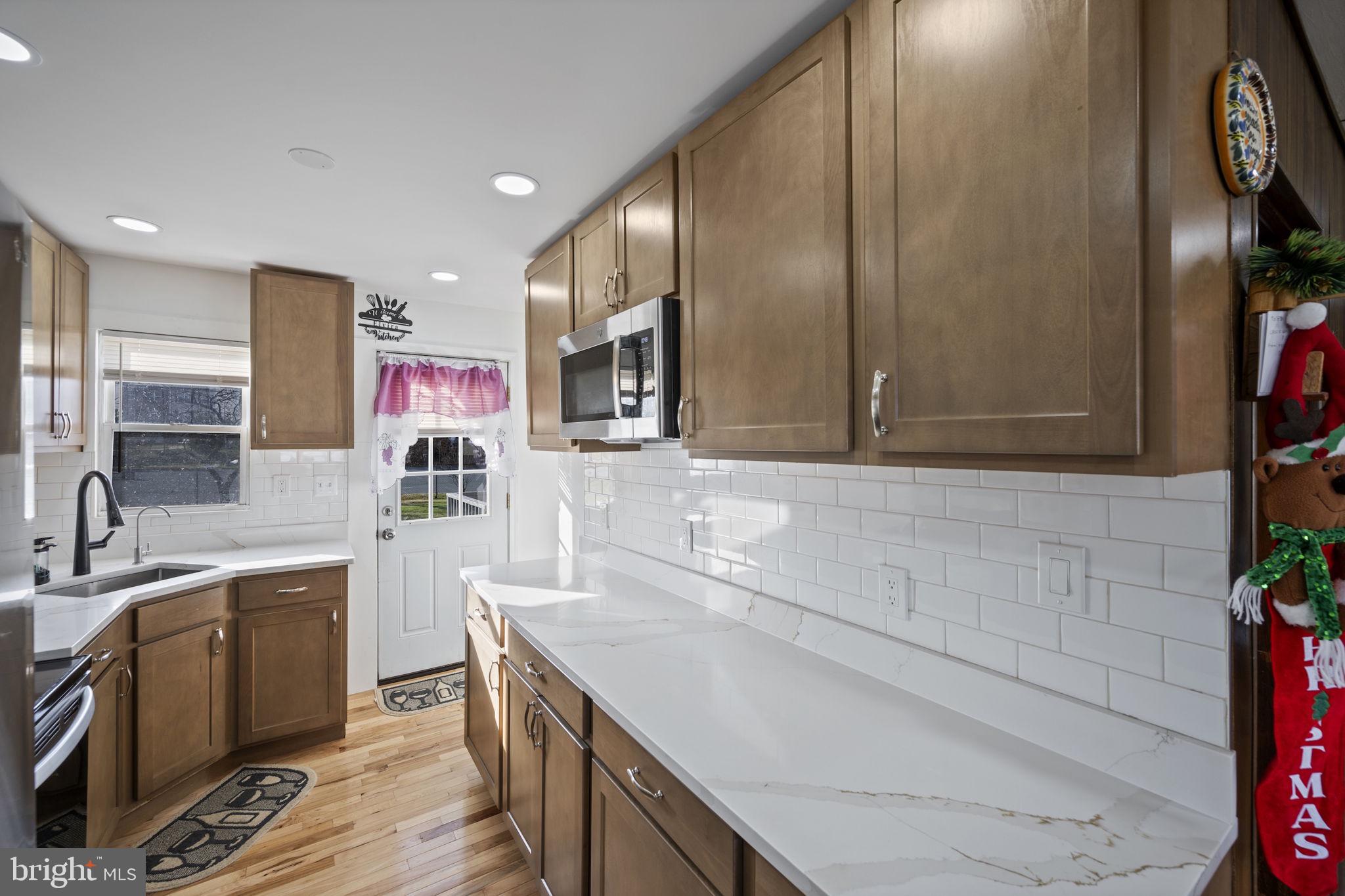 7715 Old Battle Grove Road Dundalk, MD 21222 - Photo 7 of 61 a kitchen with a sink cabinets and stainless steel appliances