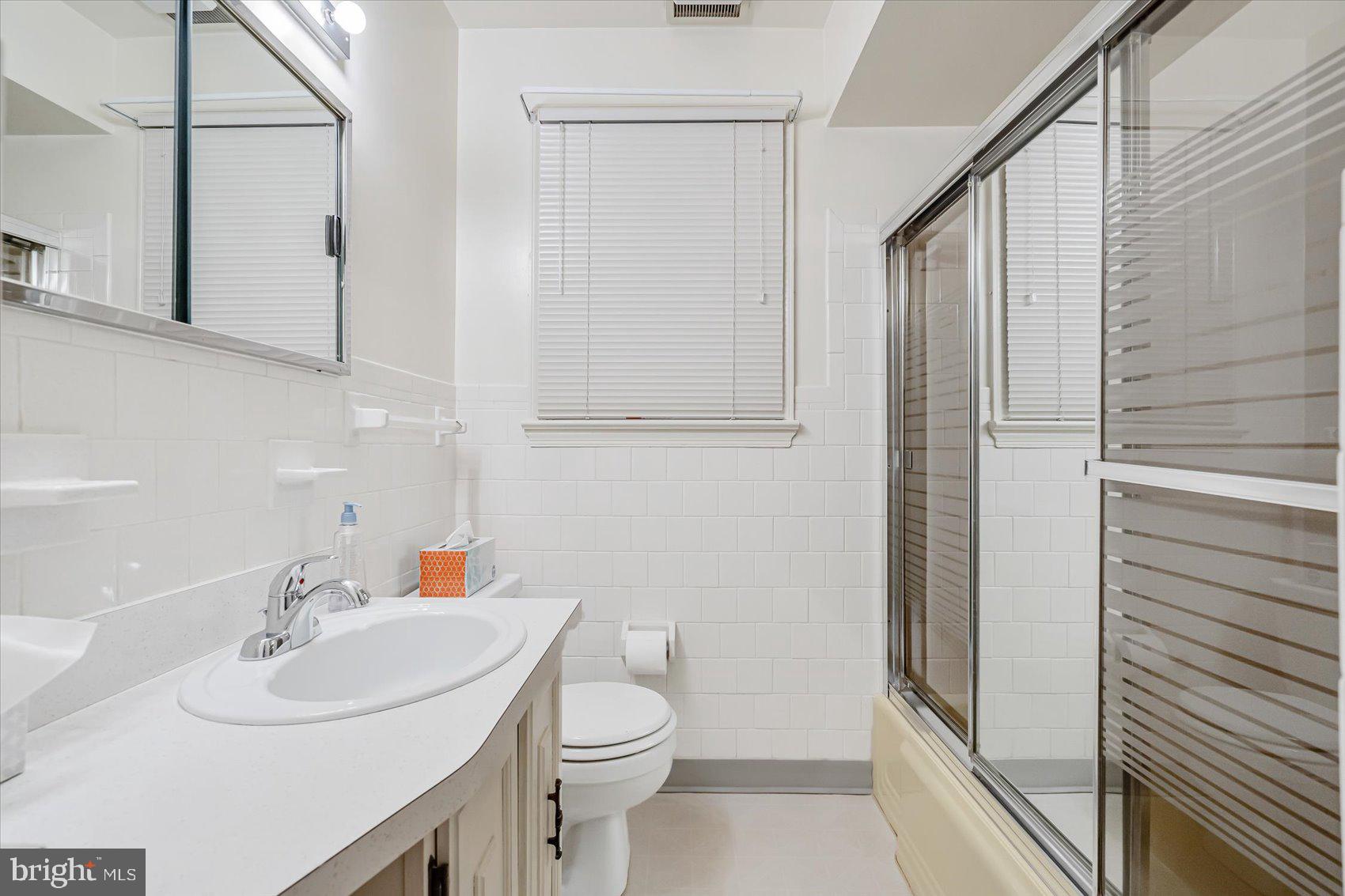 1528 Leslie Road Baltimore, MD 21222 - Photo 22 of 33 a bathroom with a sink a toilet and shower