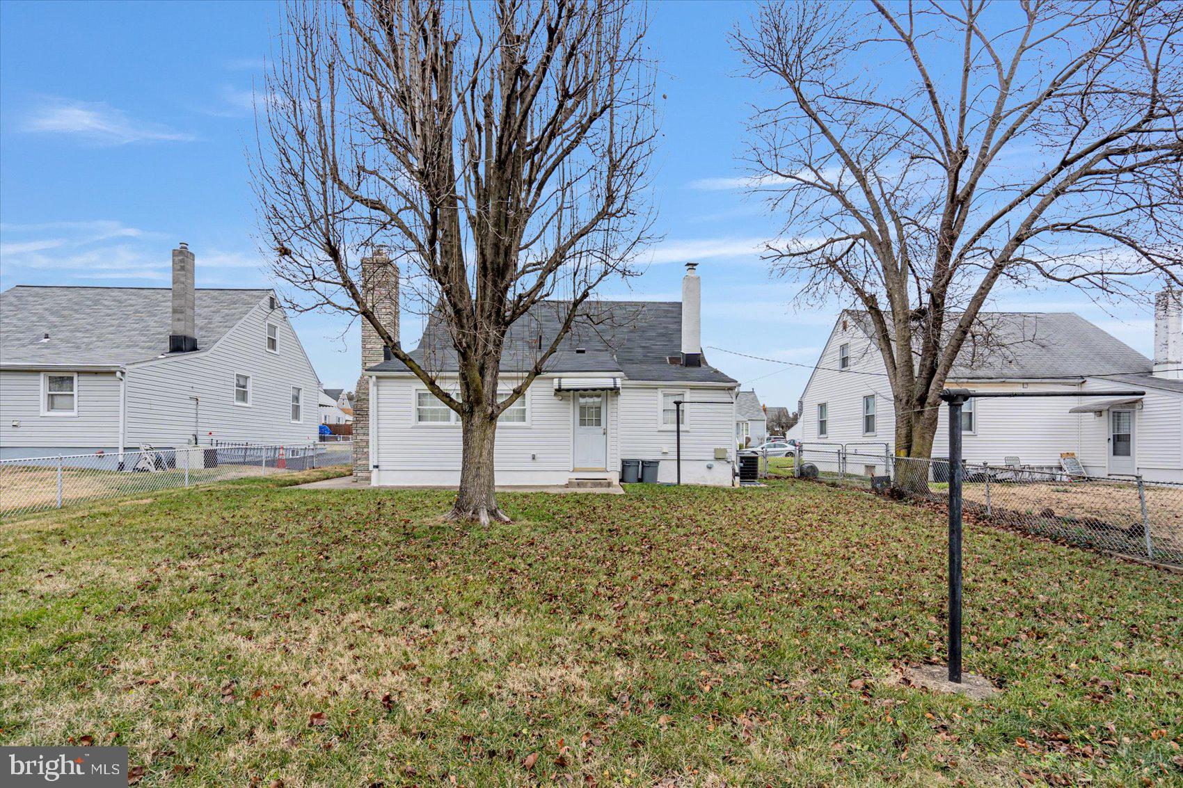 1528 Leslie Road Baltimore, MD 21222 - Photo 31 of 33 a white house that has a tree in front of it