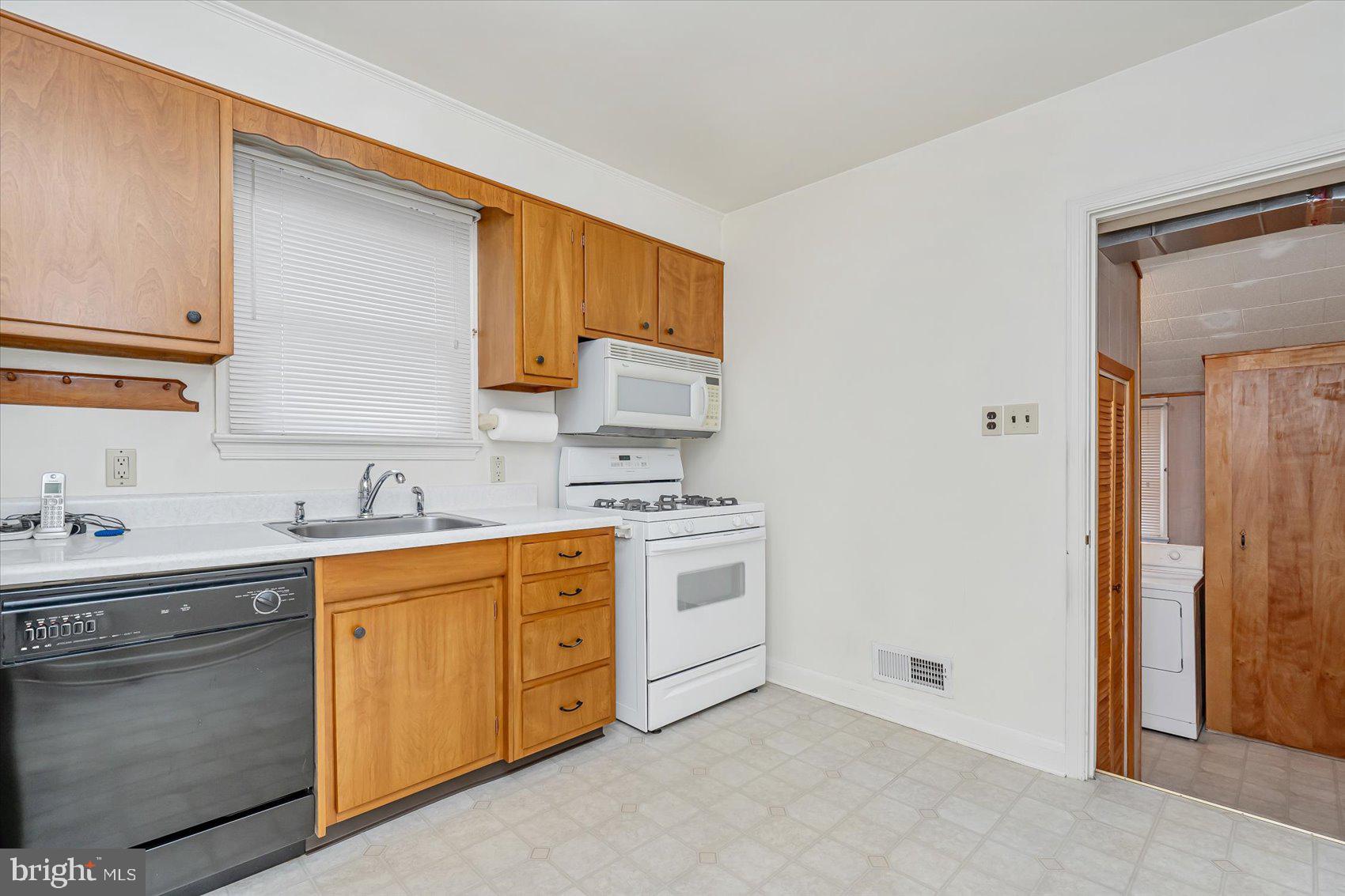 1528 Leslie Road Baltimore, MD 21222 - Photo 8 of 33 a kitchen with a sink stove and cabinets