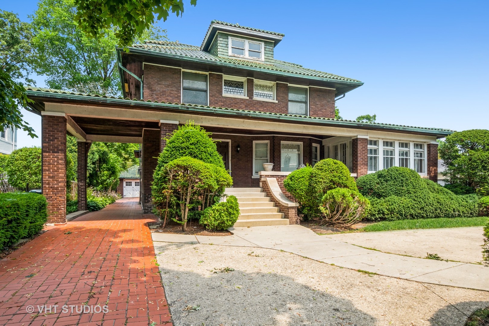 a front view of a house with a garden