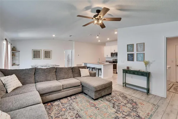 a living room with furniture and kitchen view