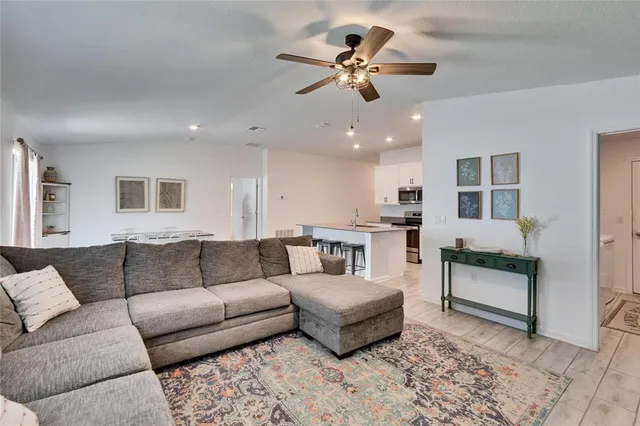 a living room with furniture and kitchen view