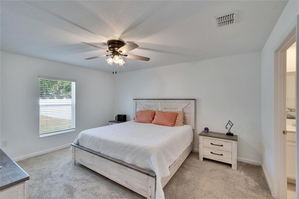 272 Pershing Street Bartow, FL 33830 - Photo 16 of 52 a bedroom with a bed and a chandelier