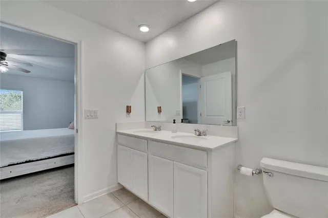 a bathroom with a sink a toilet and mirror