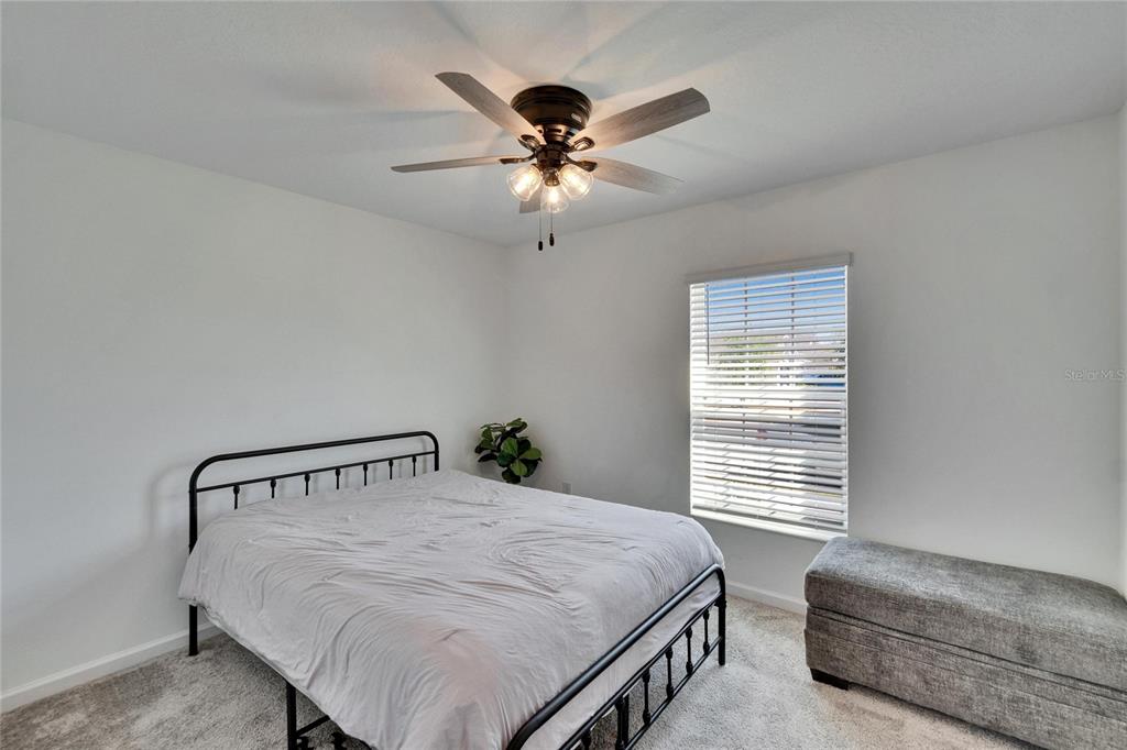 272 Pershing Street Bartow, FL 33830 - Photo 22 of 52 a bedroom with a bed and a ceiling fan