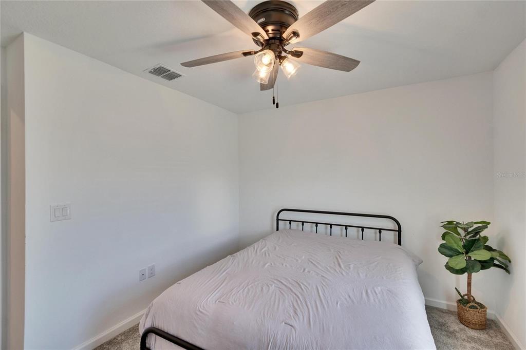 272 Pershing Street Bartow, FL 33830 - Photo 24 of 52 a bedroom with a bed and a chandelier