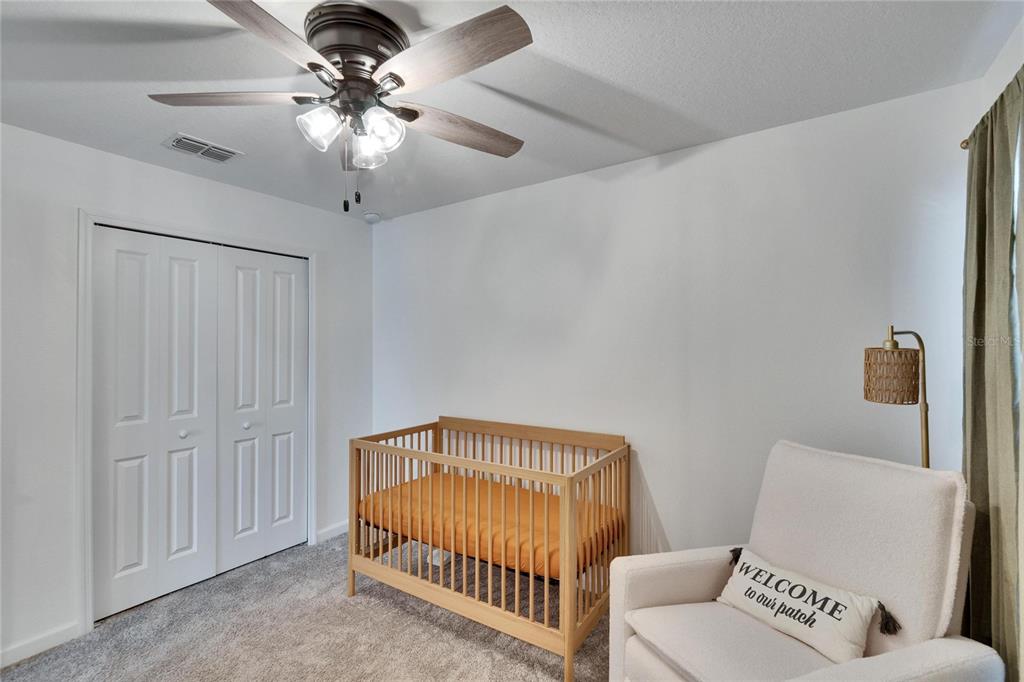 272 Pershing Street Bartow, FL 33830 - Photo 28 of 52 a bedroom with furniture and a chandelier