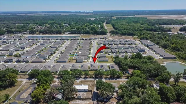an aerial view of a house with swimming pool and outdoor space