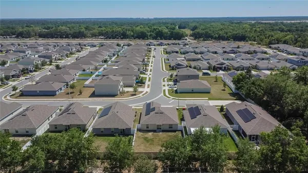 an aerial view of residential house with outdoor space and swimming pool