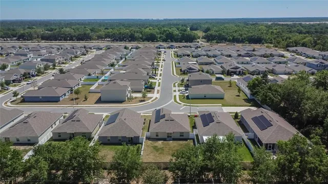 an aerial view of residential house with outdoor space and swimming pool