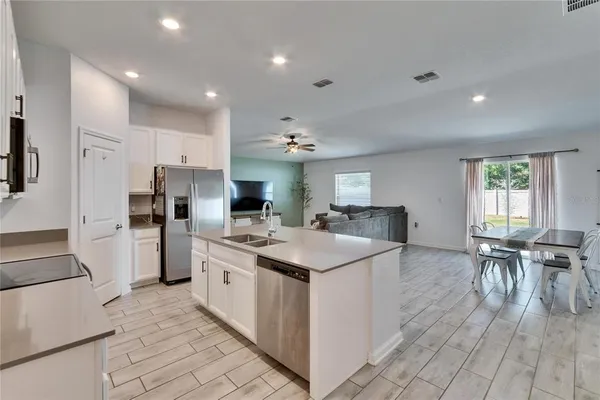 a kitchen with stainless steel appliances kitchen island granite countertop a sink and cabinets