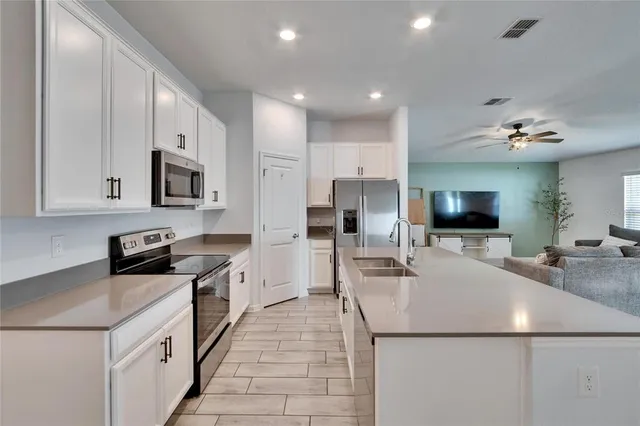 a kitchen with stainless steel appliances granite countertop a sink and cabinets