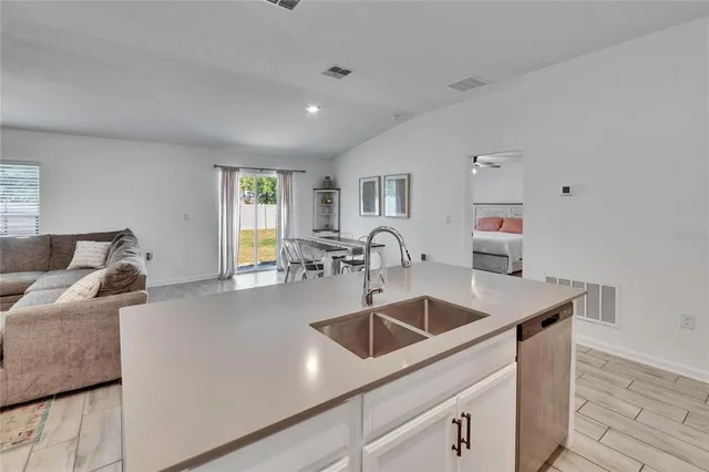 a kitchen with a sink a counter and cabinets