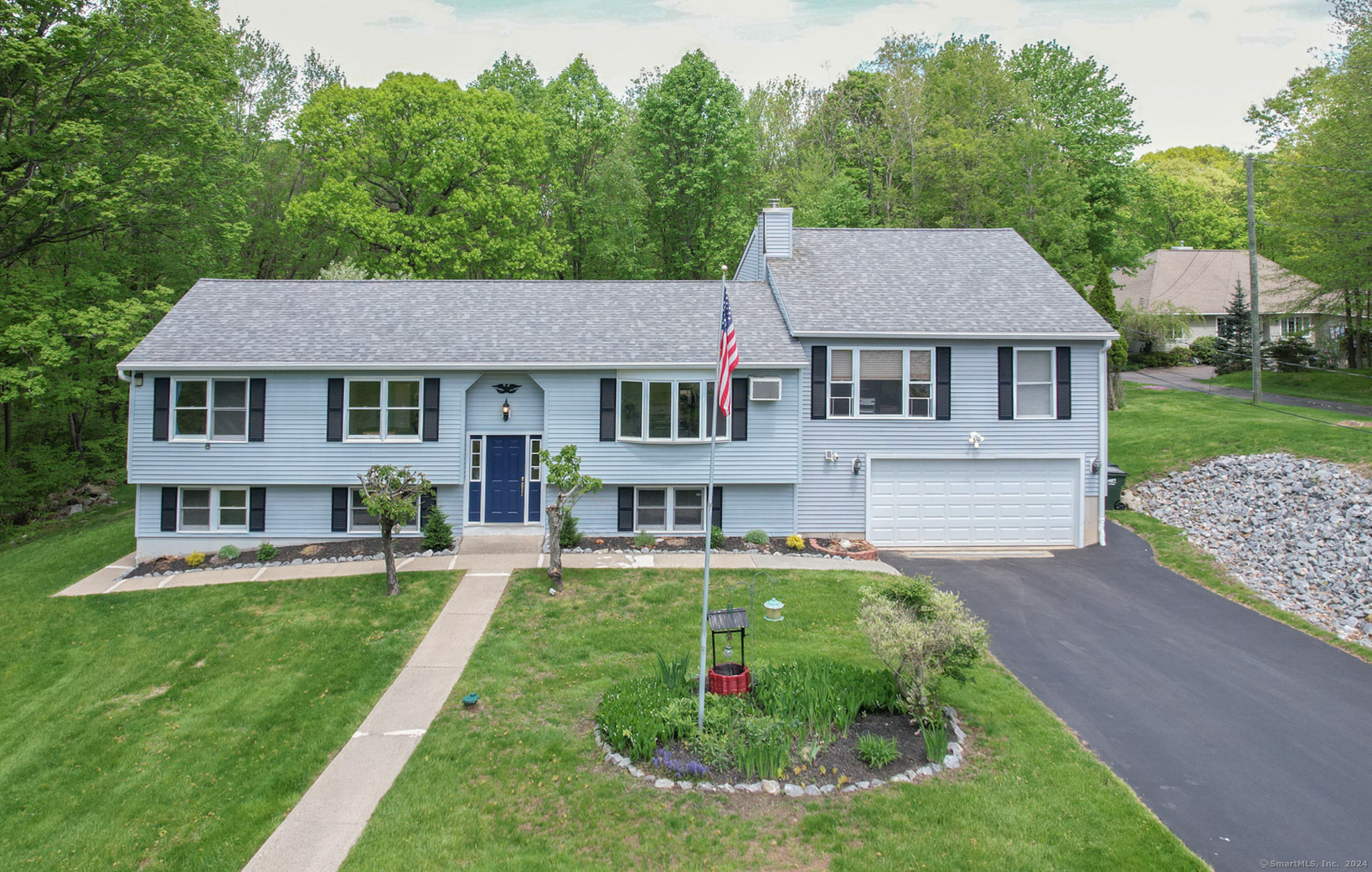 a view of a house with a yard patio and sitting area