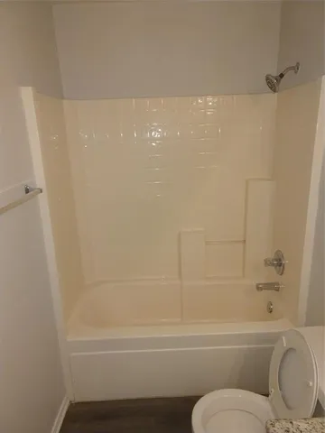 a bathroom with a toilet and a bathtub