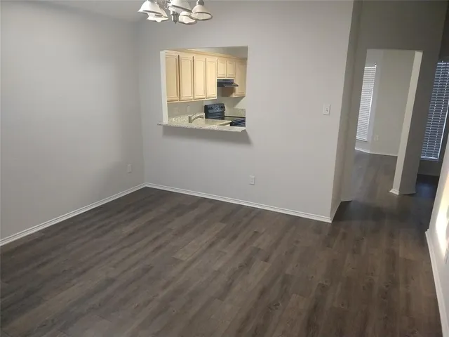 a view of a room with wooden floor and a window