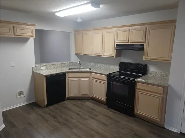 a kitchen with a sink stove and cabinets