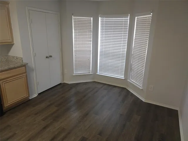 a view of a livingroom with wooden floor and a window