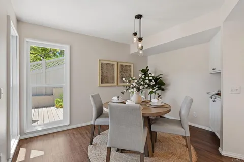a dining room with furniture and window