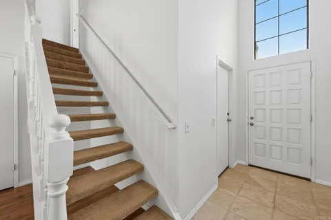 a view of entryway with wooden floor and stairs