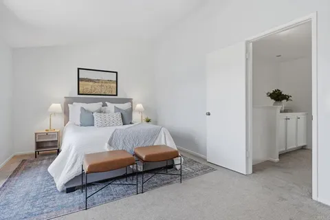 a bedroom with a bed and a painting on the wall