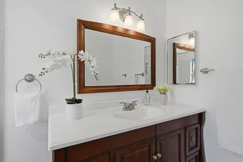 a white bath tub sitting next to a shower