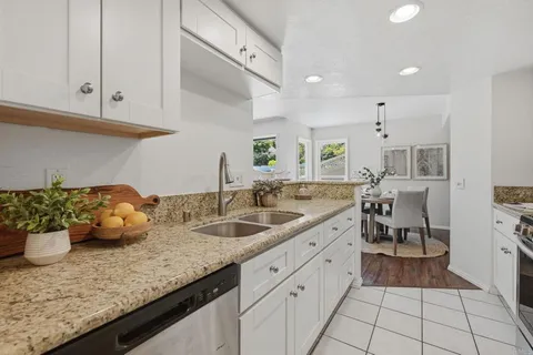 a kitchen with stainless steel appliances granite countertop a sink and cabinets