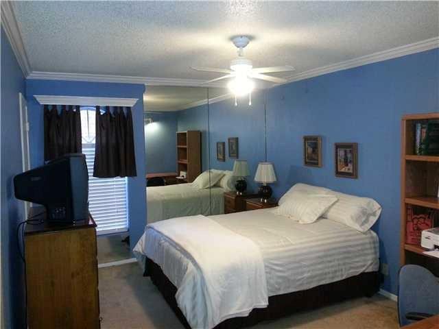 910 Duncan Lane, Unit 11 Austin, TX 78705 - Photo 3 of 5 Carpeted bedroom featuring a textured ceiling, ornamental molding, and a ceiling fan
