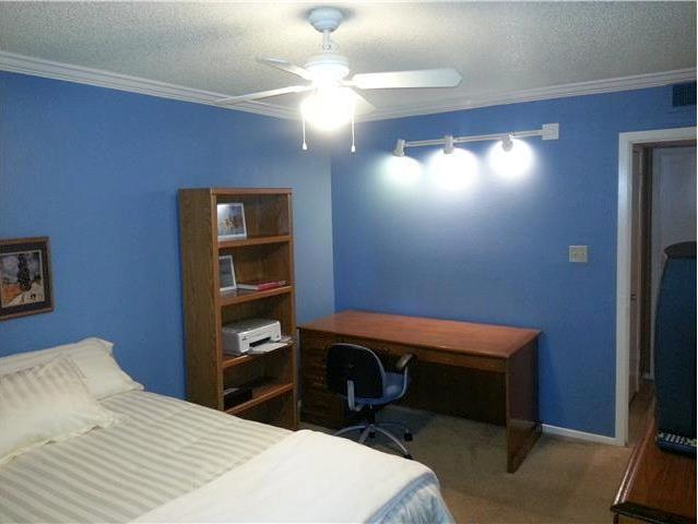 910 Duncan Lane, Unit 11 Austin, TX 78705 - Photo 4 of 5 Carpeted bedroom with a textured ceiling, ceiling fan, crown molding, and an office area