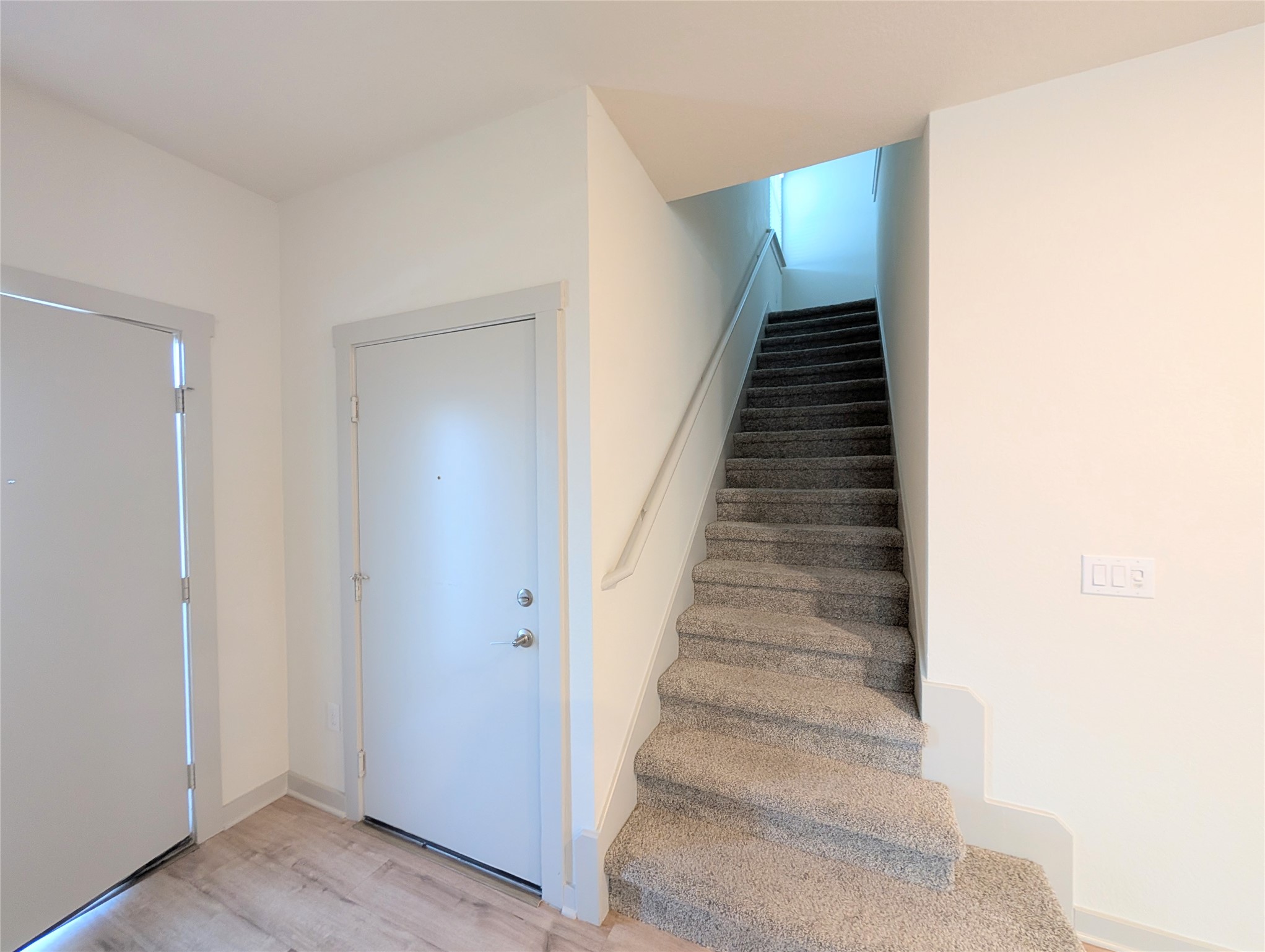 261 Century Plant Road Leander, TX 78641 - Photo 14 of 25 A welcoming entryway with durable flooring transitions to a plush carpeted staircase.