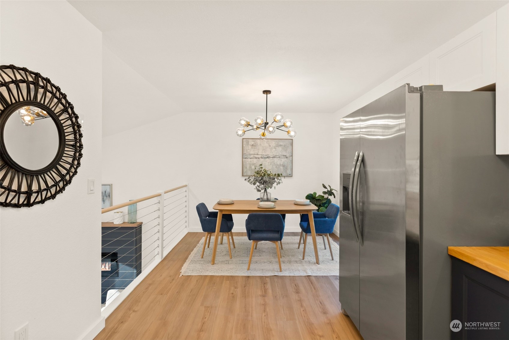 22612 20th Avenue Southeast Bothell, WA 98021 - Photo 11 of 35 a view of a dining room with furniture a chandelier and wooden floor