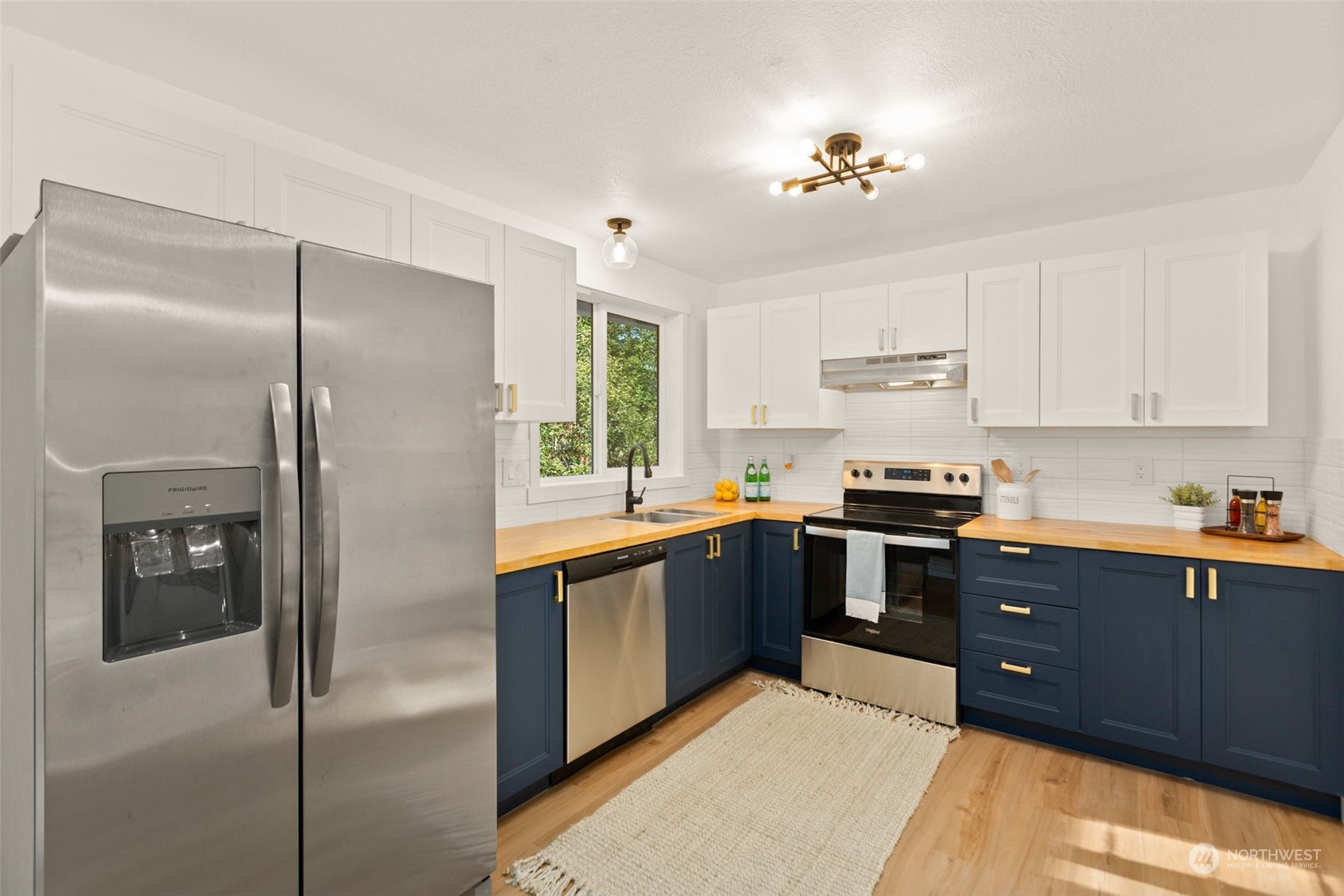 22612 20th Avenue Southeast Bothell, WA 98021 - Photo 15 of 35 a kitchen with stainless steel appliances granite countertop a refrigerator and a sink