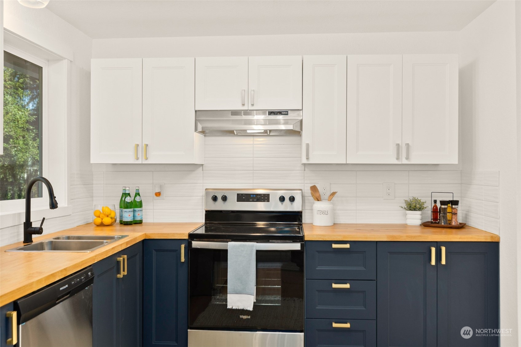 22612 20th Avenue Southeast Bothell, WA 98021 - Photo 16 of 35 a kitchen with stainless steel appliances granite countertop a sink stove and cabinets