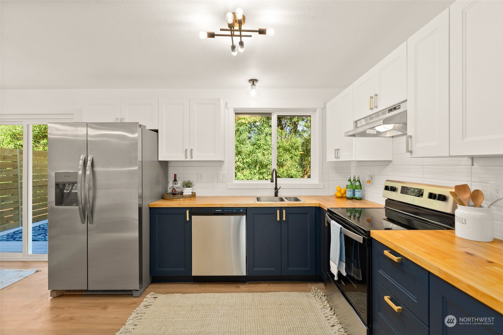 22612 20th Avenue Southeast Bothell, WA 98021 - Photo 9 of 35 a kitchen with stainless steel appliances granite countertop a sink a stove a refrigerator cabinets and a window