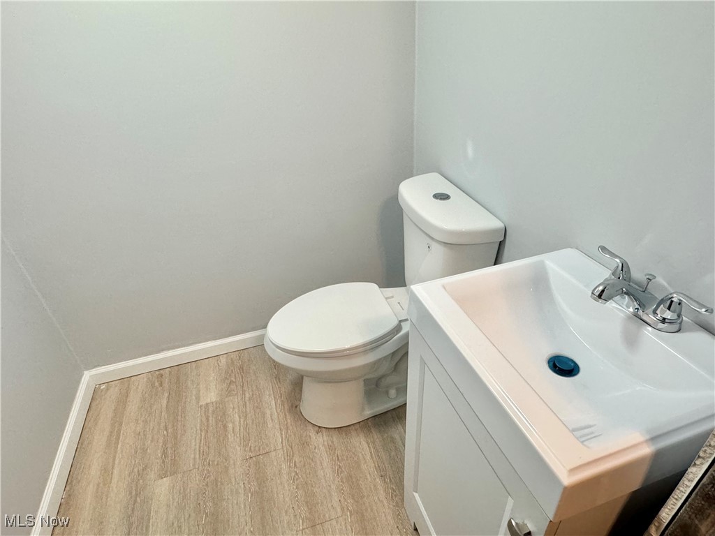 1215 Avondale Road Cleveland, OH 44121 - Photo 27 of 27 Bathroom featuring vanity, hardwood / wood-style flooring, and toilet