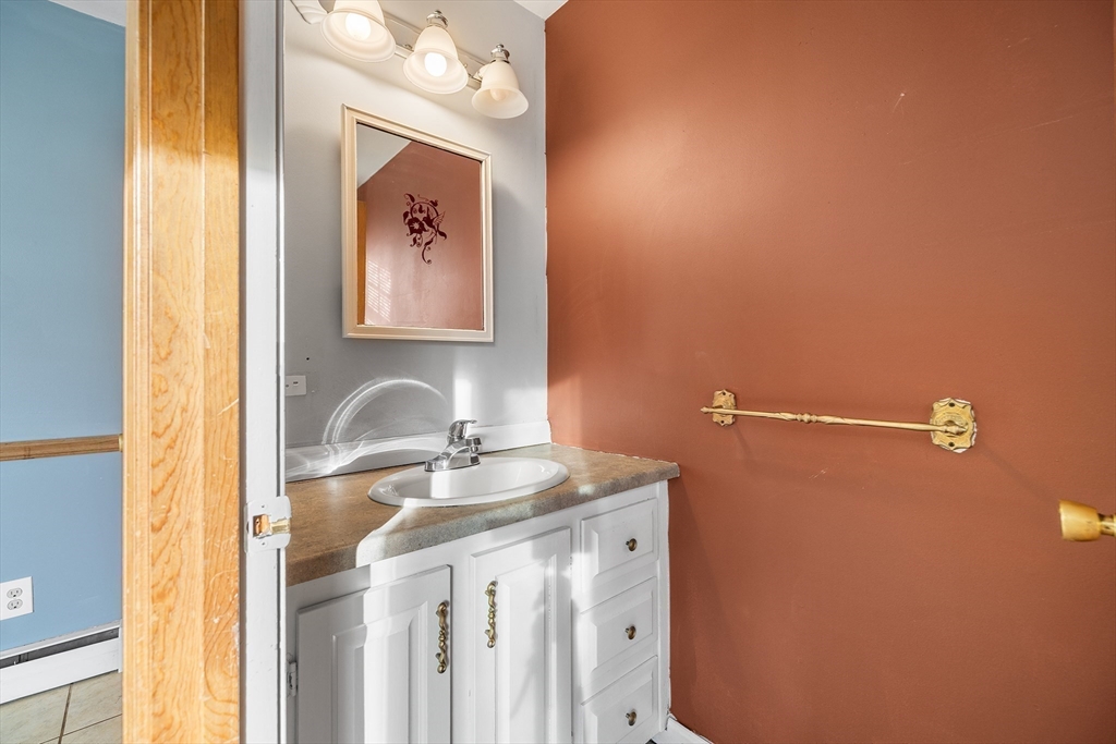 22 Pleasant Street, Unit D Lawrence, MA 01841 - Photo 11 of 32 a bathroom with a sink mirror and vanity